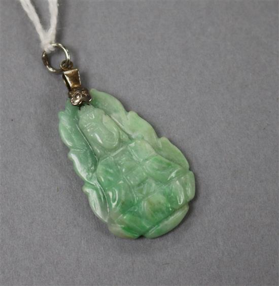 A white metal mounted carved jadeite pendant, 30mm.